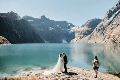 Queenstown New Zealand Elopement Wedding Photographer - A bride and groom standing in front of Lake Erskine in New Zealand.