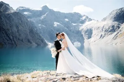 Queenstown New Zealand Elopement Wedding Photographer - A bride and groom posing in front of Lake Erskine in New Zealand.