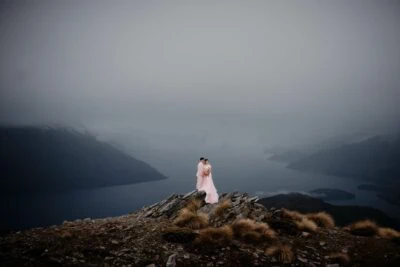 Queenstown New Zealand Elopement Wedding Photographer - A bride standing on top of Remarkables, overlooking lake Wanaka.
