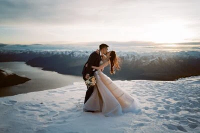Queenstown New Zealand Elopement Wedding Photographer - A bride and groom kissing on top of The Remarkables in Queenstown, New Zealand.