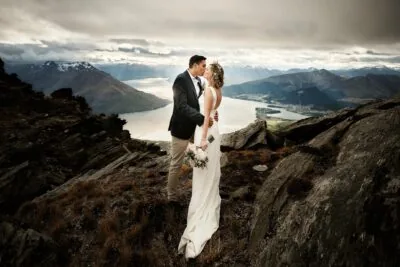 Queenstown New Zealand Elopement Wedding Photographer - A bride and groom standing on top of the Remarkables, overlooking Lake Wanaka.