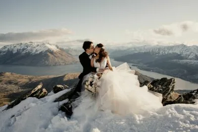 Queenstown New Zealand Elopement Wedding Photographer - Bride and groom kissing on top of the Remarkables, a snowy mountain in Queenstown, New Zealand.