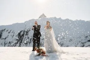 Queenstown New Zealand Elopement Wedding Photographer -         A bride and groom having a playful snow fight on a glacier.