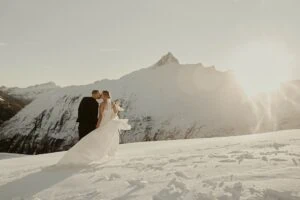 Queenstown New Zealand Elopement Wedding Photographer - A bride and groom standing on top of Tyndall Glacier, a snow-covered mountain.