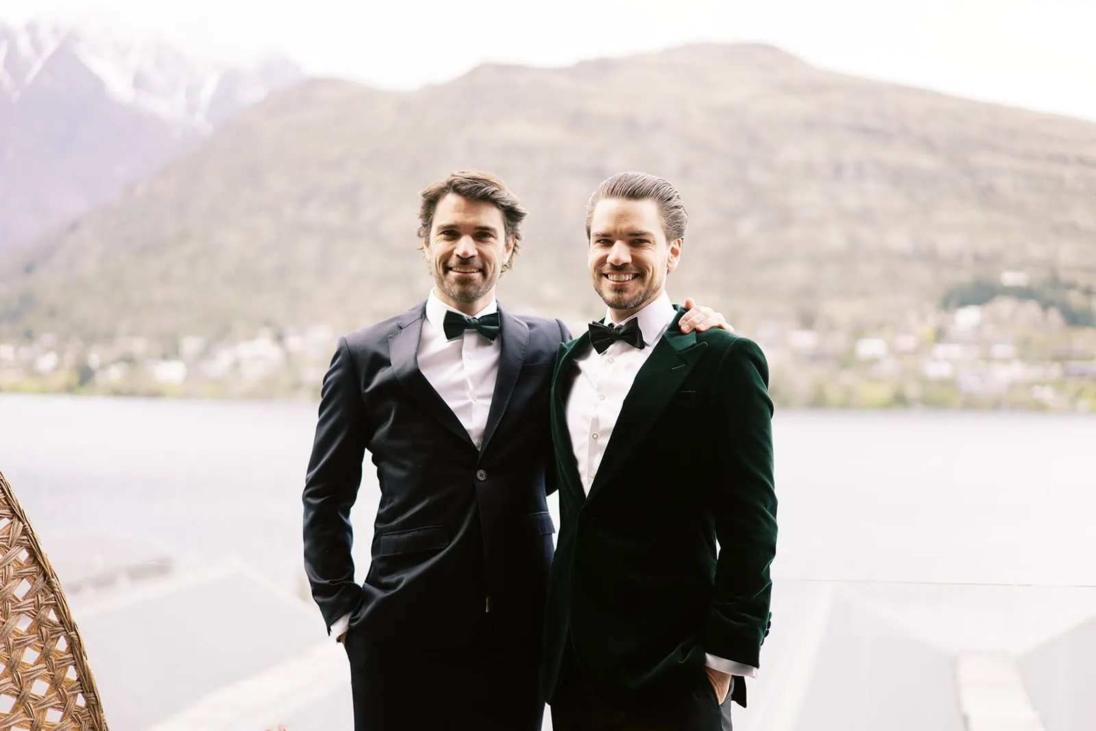 Queenstown Wedding Photographer Two men in tuxedos standing next to a lake during their EloPement Wedding.