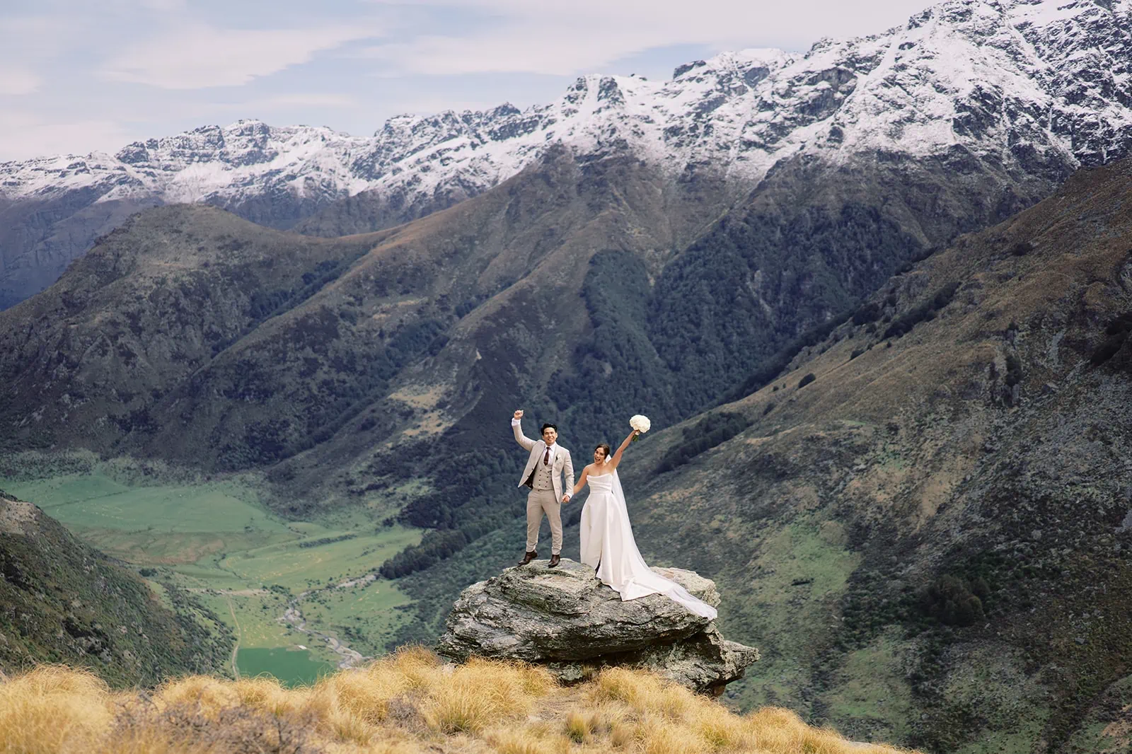 Queenstown Elopement Heli Wedding Photographer クイーンズタウン結婚式 | Ceidi & Tobi, a bride and groom, standing on top of StoneRidge mountain in Queenstown during their wedding in New Zealand.