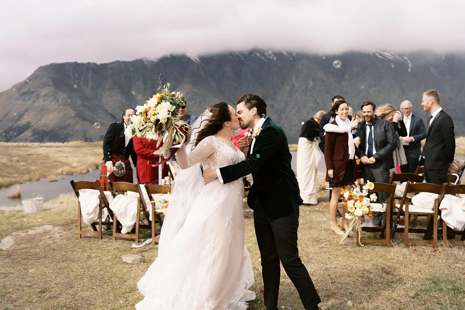 Queenstown Wedding Photographer Nat & Tim's Queenstown elopement wedding captured their heartfelt moment of a bride and groom kissing in front of the breathtaking mountains at Deer Park Heights.
