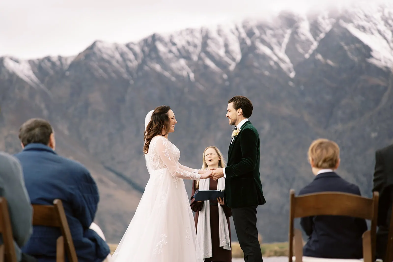 Queenstown Wedding Photographer Nat & Tim, a bride and groom, have their Queenstown EloPement Wedding at Deer Park Heights, exchanging vows in front of majestic mountains.