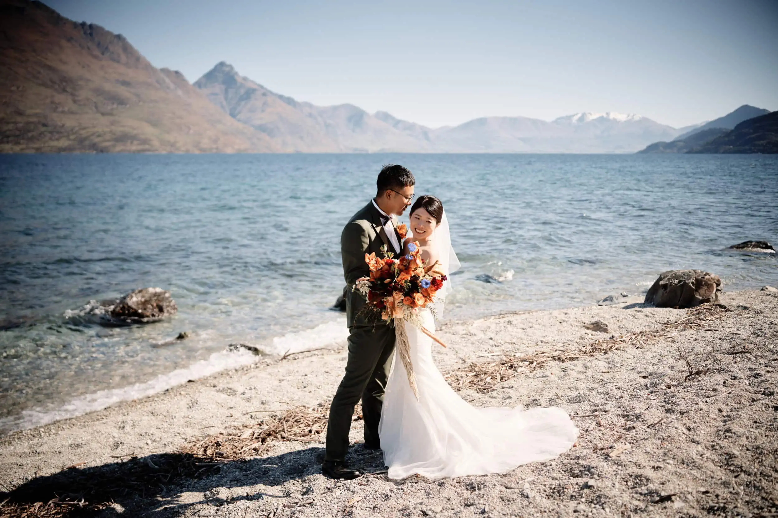 Queenstown Wedding Photographer A bride and groom enjoying a romantic Pre Wedding Shoot on the shore of Lake Wanaka near Queenstown.