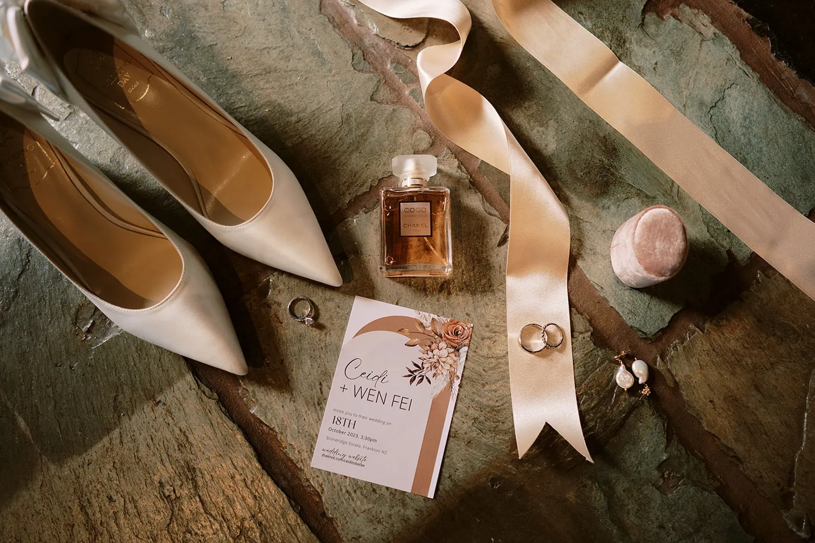 Queenstown Elopement Heli Wedding Photographer クイーンズタウン結婚式 | A pair of Tobi wedding shoes and a bottle of Queenstown perfume on a wooden table.