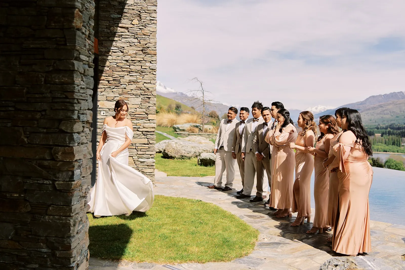 Queenstown Elopement Heli Wedding Photographer クイーンズタウン結婚式 | A group of bridesmaids standing in front of a StoneRidge stone wall.