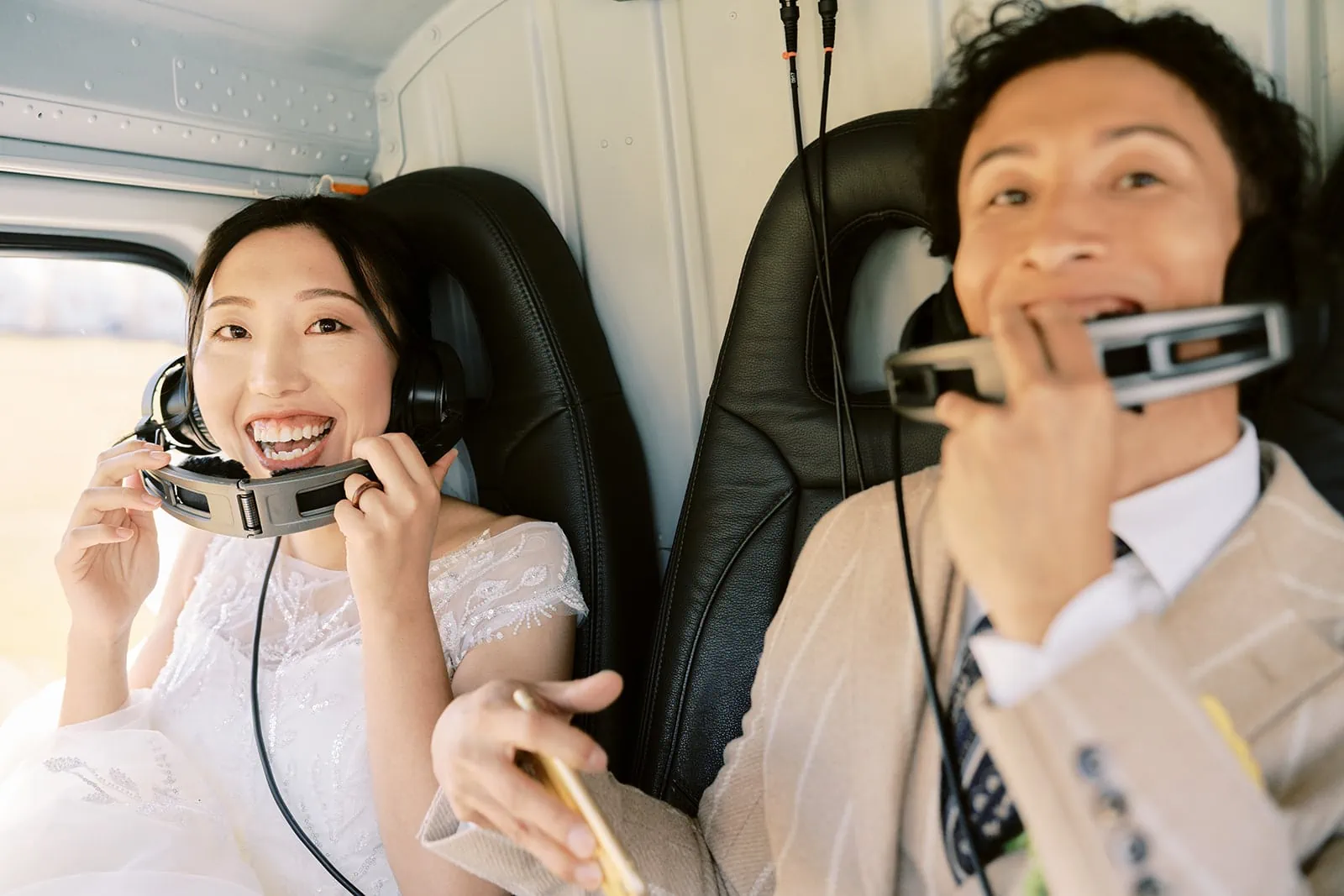Queenstown Elopement Heli Wedding Photographer クイーンズタウン結婚式 | A bride and groom sitting in a plane in Queenstown.