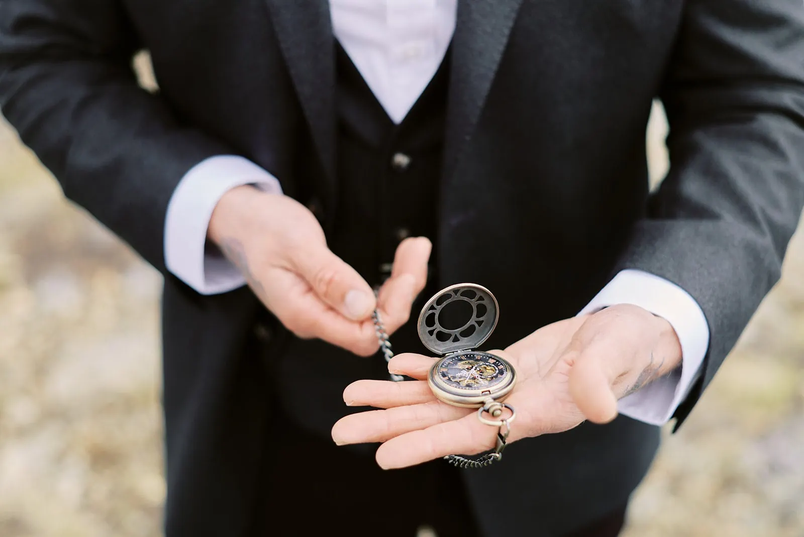 Queenstown Elopement Heli Wedding Photographer クイーンズタウン結婚式 | A man in a suit holding a pocket watch, capturing the essence of an elegant love story.