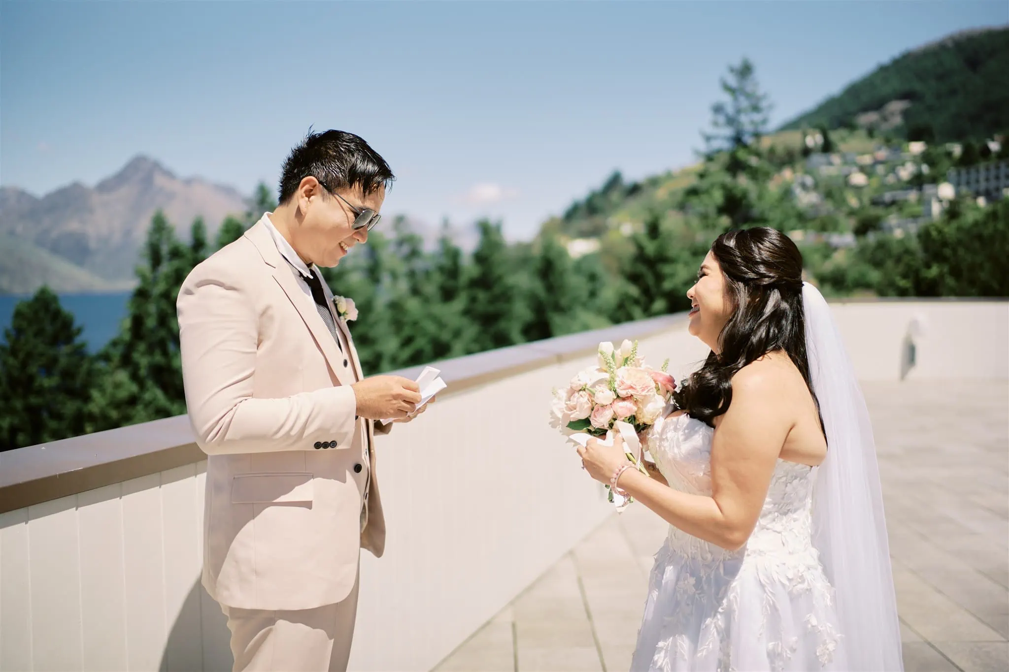 Queenstown Elopement Heli Wedding Photographer クイーンズタウン結婚式 | A Queenstown elopement featuring a bride and groom gazing at each other on a balcony.