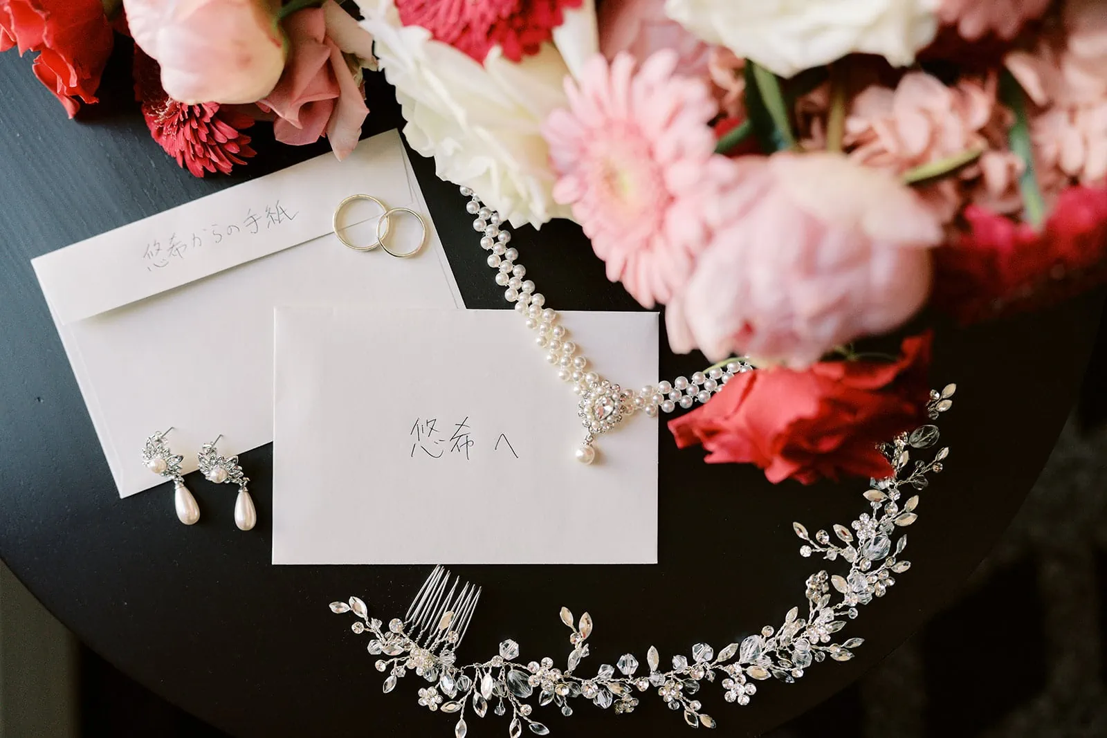 Queenstown Elopement Heli Wedding Photographer クイーンズタウン結婚式 | A bouquet of flowers and jewelry, belonging to Ayaka, sits on a table.
