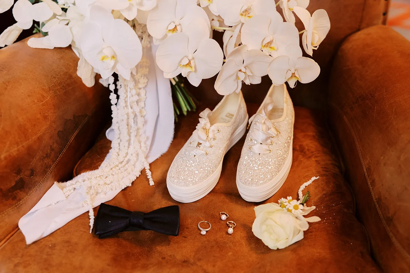 Queenstown Elopement Heli Wedding Photographer クイーンズタウン結婚式 | A pair of shoes and a bouquet of white orchids for a pre-wedding photoshoot.