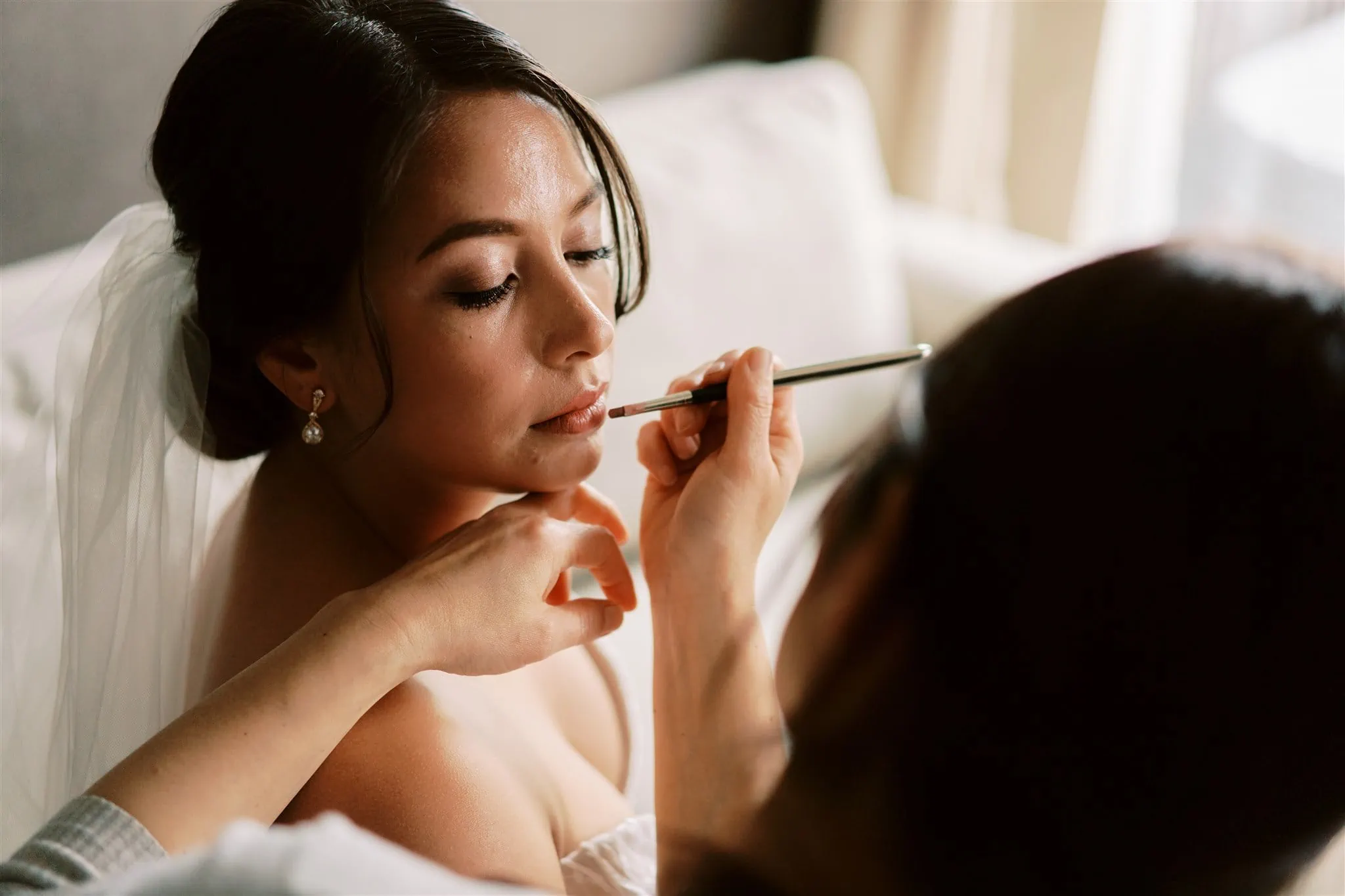 Queenstown Elopement Heli Wedding Photographer クイーンズタウン結婚式 | Mariah, a makeup artist in Queenstown, expertly applies makeup on a radiant bride as she prepares for her special day.