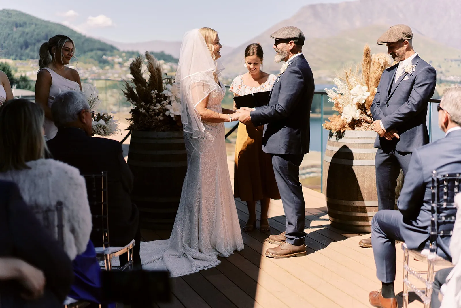 Queenstown Elopement Heli Wedding Photographer クイーンズタウン結婚式 | Melissa & Scott exchange vows on the deck of Kamana Lakehouse in Queenstown, New Zealand.