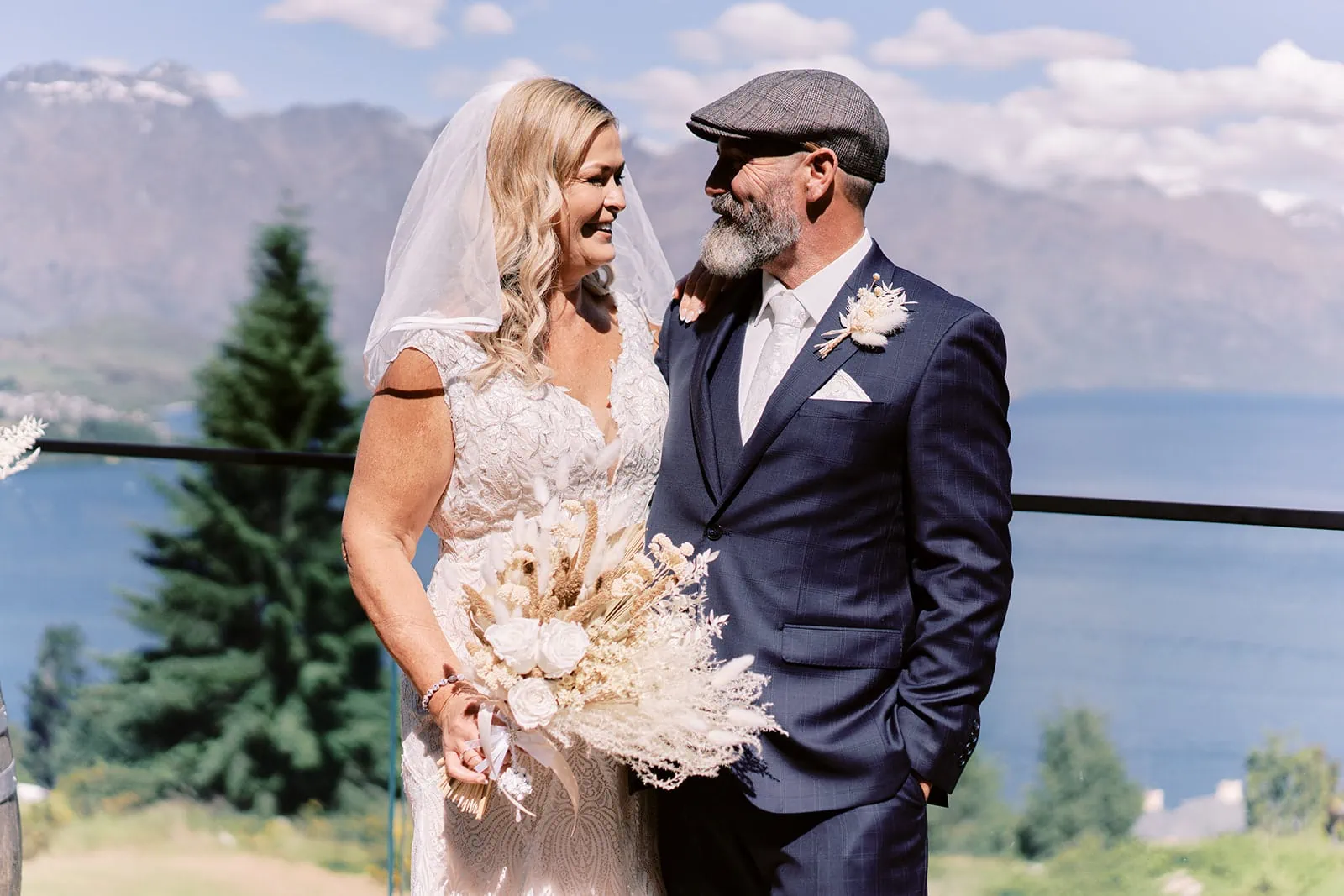 Queenstown Elopement Heli Wedding Photographer クイーンズタウン結婚式 | Melissa and Scott, a bride and groom, are captured in a breathtaking moment on the balcony of Kamana Lakehouse. Overlooking Lake Wanaka, their elopement at this Queenstown