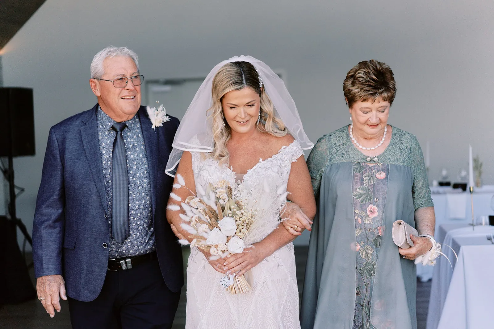 Queenstown Elopement Heli Wedding Photographer クイーンズタウン結婚式 | Melissa walking down the aisle with her parents at Kamana Lakehouse.