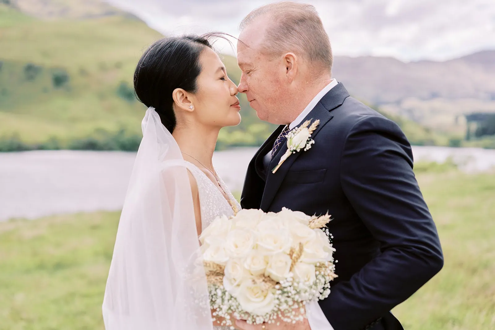 Queenstown Elopement Heli Wedding Photographer クイーンズタウン結婚式 | Joel and Meng, a man and woman, sharing a passionate kiss at Stoneridge Estate.