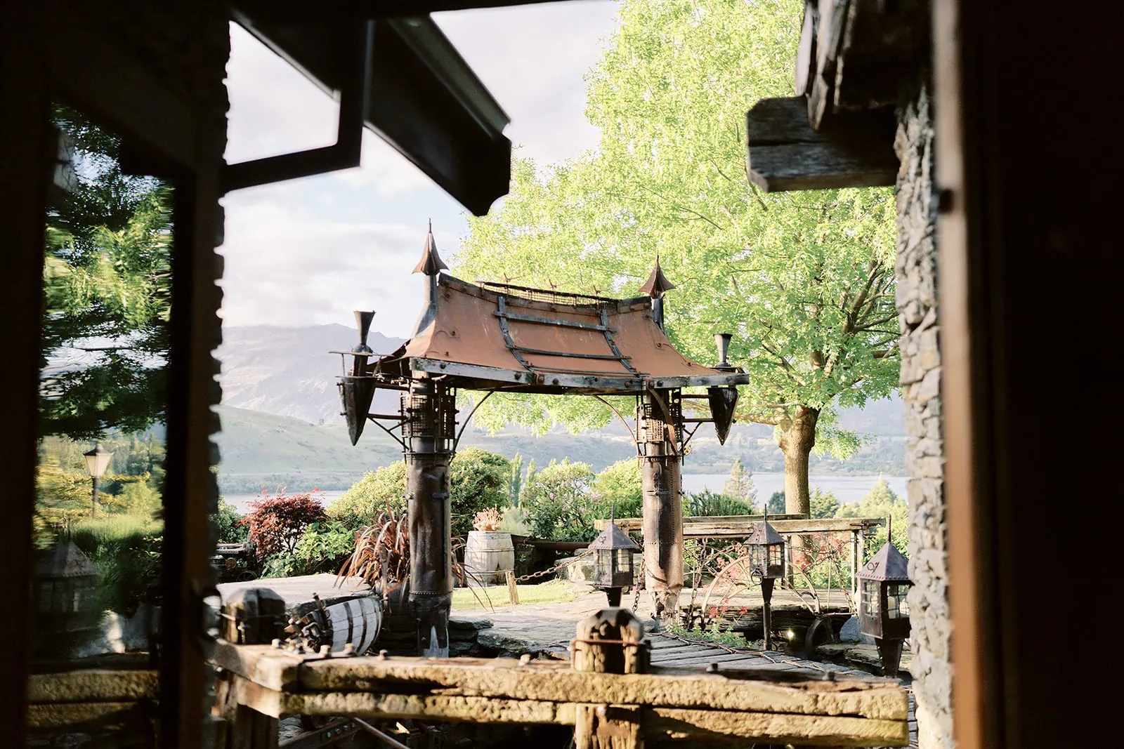 Queenstown Elopement Heli Wedding Photographer クイーンズタウン結婚式 | Through a doorway, a pagoda is seen at Queenstown Stoneridge Estate.