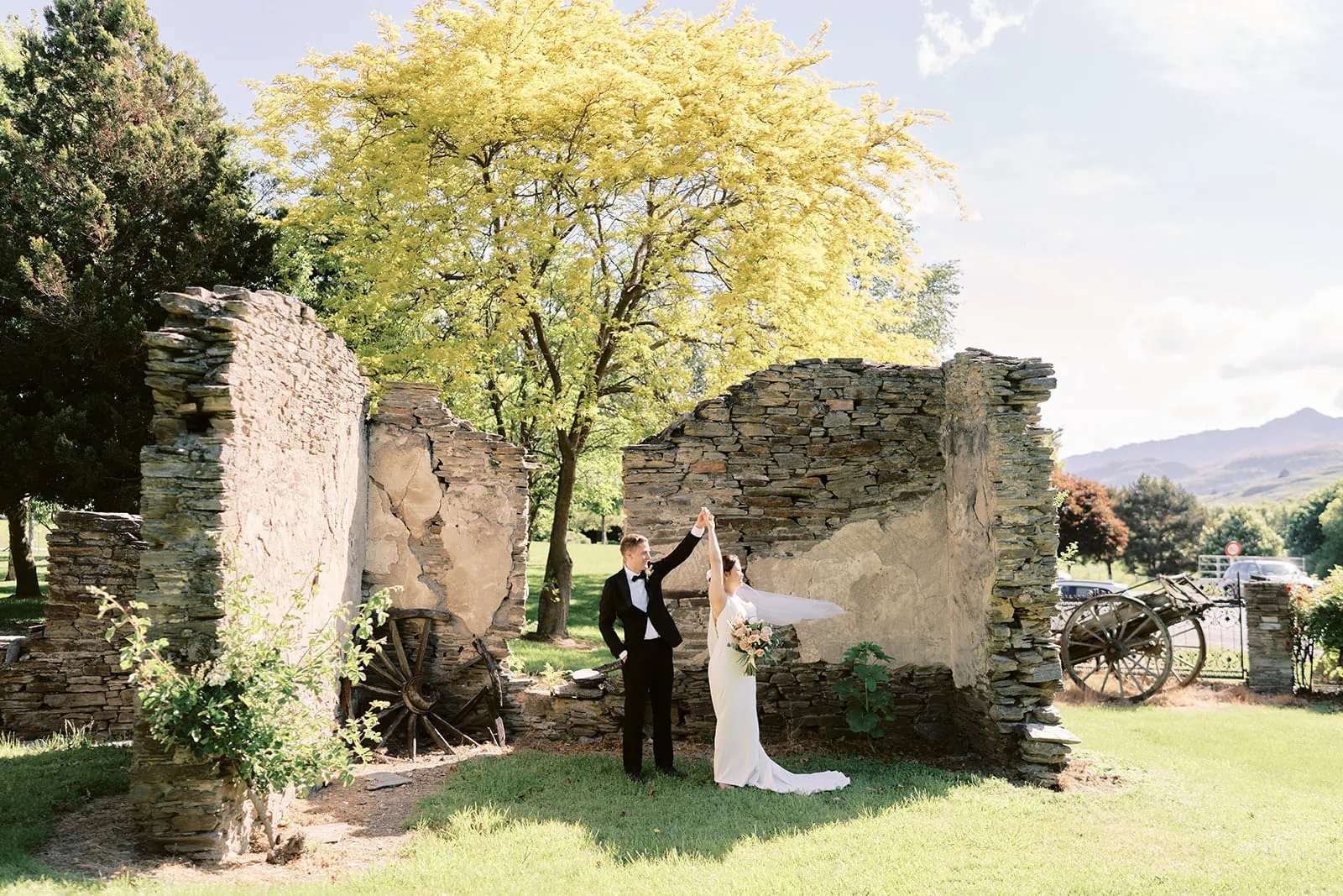 Queenstown Elopement Heli Wedding Photographer クイーンズタウン結婚式 | Shane and MJ, the bride and groom, strike a pose in front of the majestic Stoneridge Queenstown ruins.