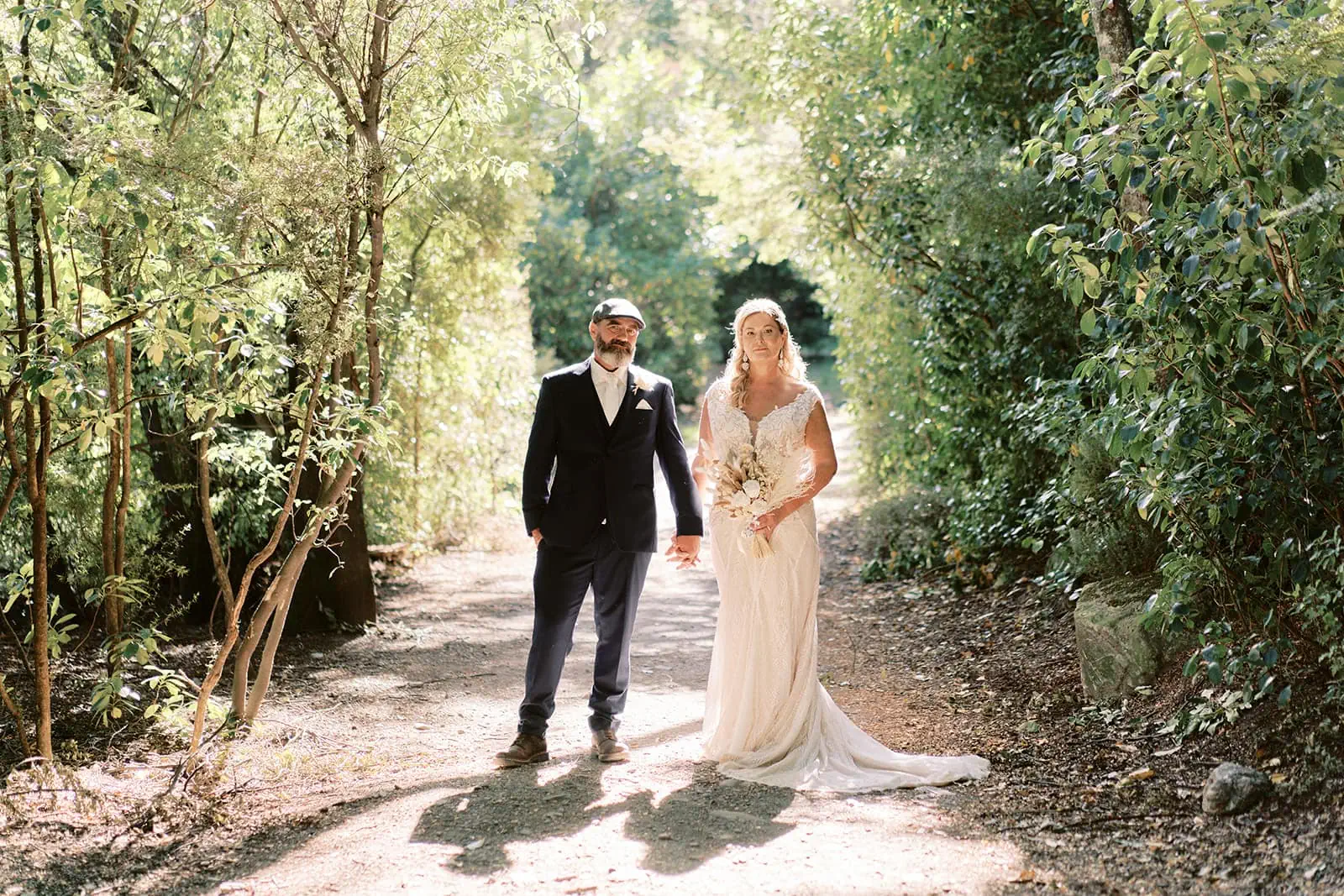 Queenstown Elopement Heli Wedding Photographer クイーンズタウン結婚式 | Melissa & Scott, in their Queenstown Elopement, stroll through the enchanting woods near Kamana Lakehouse.