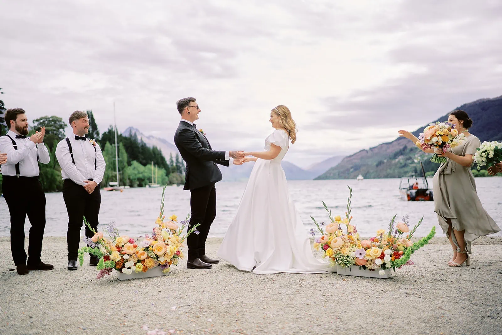 Queenstown Elopement Heli Wedding Photographer クイーンズタウン結婚式 | Sophie and Thomas, a bride and groom, exchange vows in front of a lake in Queenstown.
